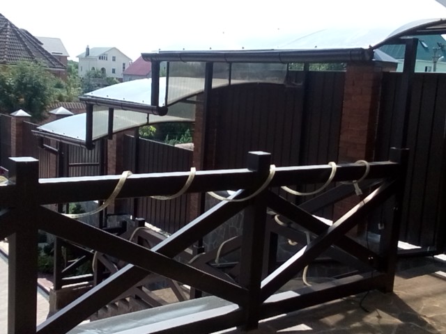 Polycarbonate canopy over terrace and stairs